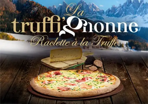 La pizza Truffi'gnonne Basilic & Co, sur une table en bois, avec une vue sur les montagnes enneigées en fond.
